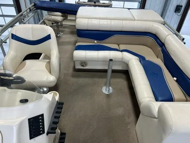 Slide: The Image of 2004 Godfrey F20 boat interior with white and blue seating. - 7