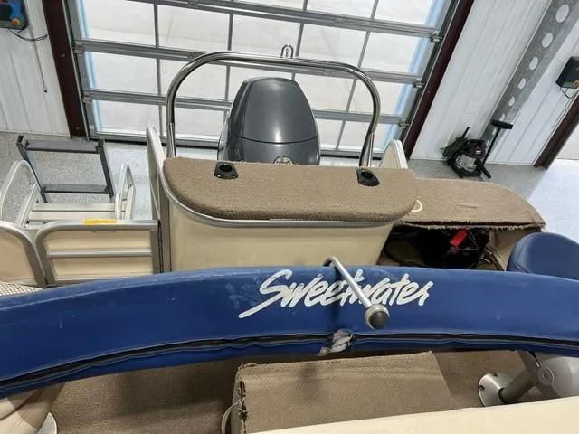 Slide: The Image of Godfrey F20 Sweetwater pontoon boat, 2004 model, in a garage setting. - 8