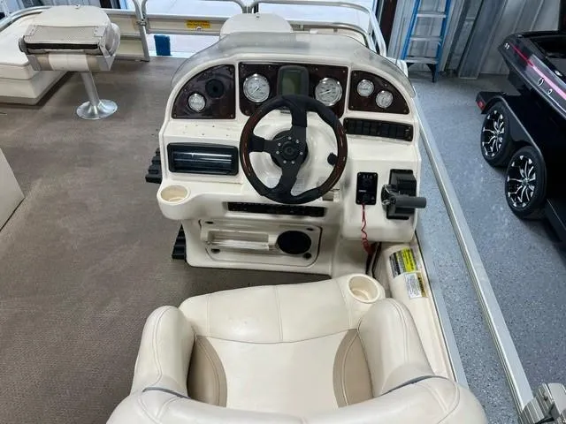 Slide: The Image of 2004 Godfrey F20 boat dashboard with steering wheel and gauges. - 9