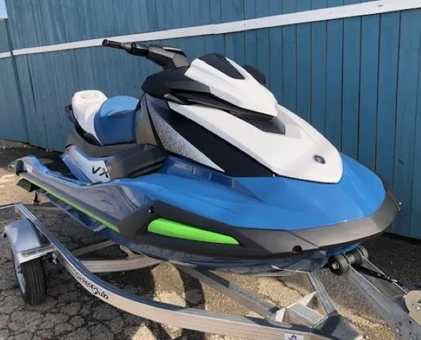 Slide: The Image of 2024 Yamaha WaveRunner VX Cruiser in blue on trailer, parked by blue wall. - 2