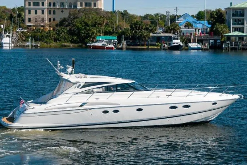 Slide: The Image of 2006 Princess 58v yacht cruising on a scenic waterfront. - 1
