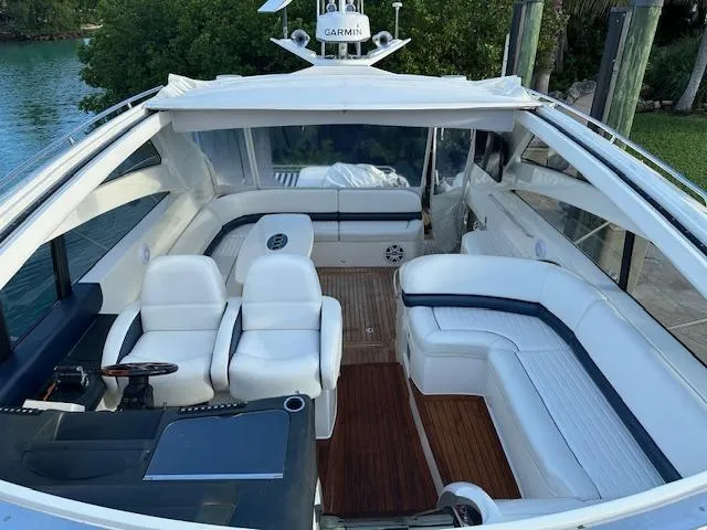 Slide: The Image of Luxurious 2006 Princess 58v yacht interior with white seating and wooden flooring. - 14