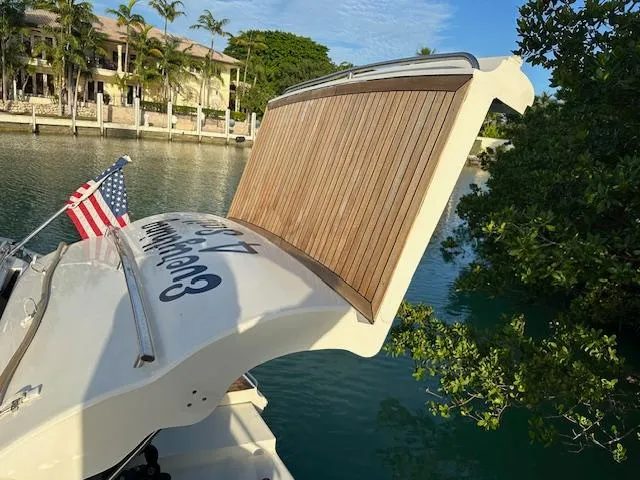 Slide: The Image of 2006 Princess 58v yacht with American flag, docked near waterfront homes. - 17