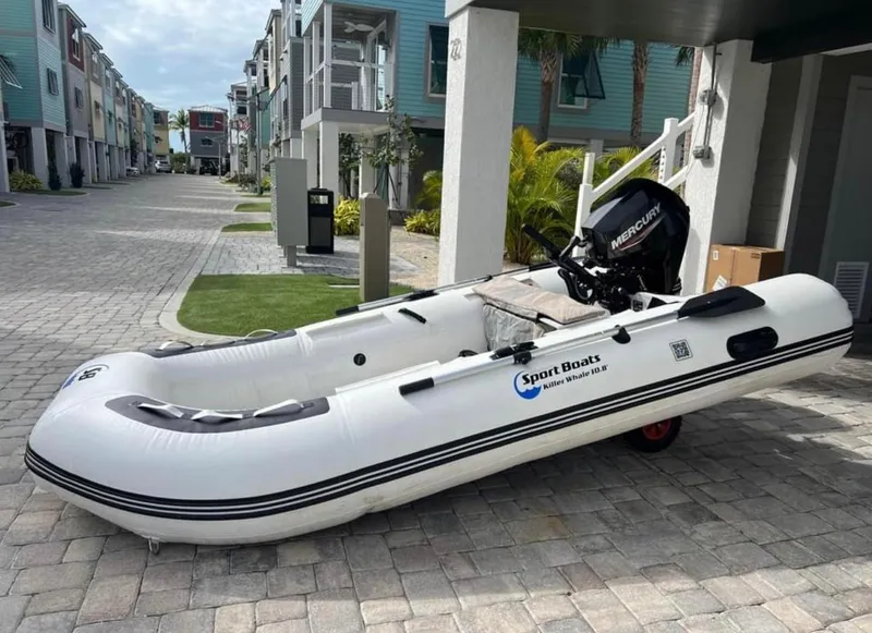 Slide: The Image of Inflatable boat with Mercury motor on a cobblestone street, surrounded by modern buildings. - 2