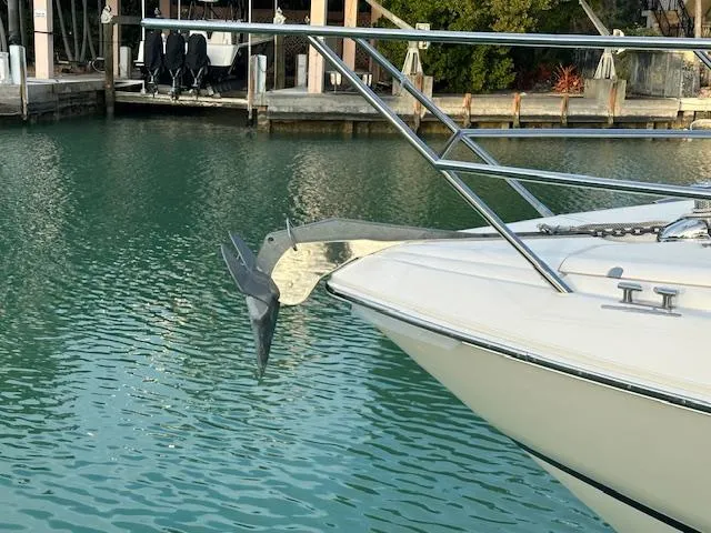 Slide: The Image of Bow of 2006 Princess 58v yacht with anchor, docked in calm water. - 21