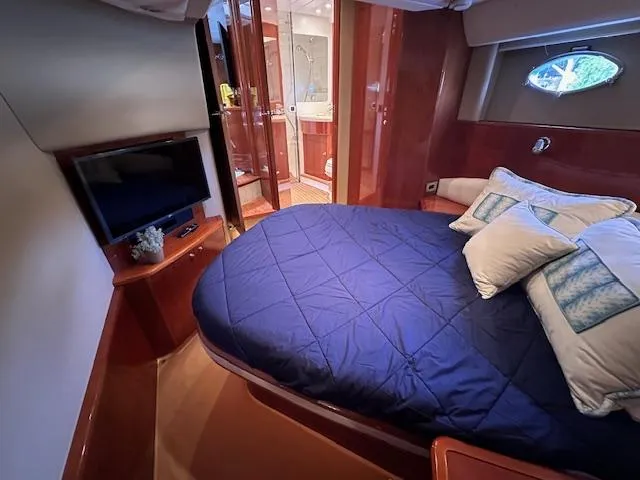 Slide: The Image of Luxurious cabin interior of 2006 Princess 58v yacht with cozy bed and TV. - 24