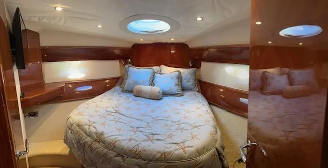 Slide: The Image of Luxurious cabin interior of 2006 Princess 58v yacht with cozy bedding and elegant wood finish. - 3