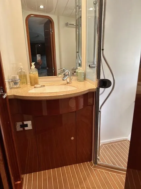 Slide: The Image of Luxurious bathroom in 2006 Princess 58v yacht with modern fixtures and wooden accents. - 4