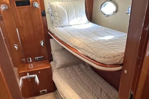 Slide: The Image of 2006 Princess 58v yacht cabin with bunk beds and porthole windows. - 45