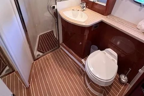 Slide: The Image of Luxurious yacht bathroom with wood flooring, shower, and modern fixtures in a 2006 Princess 58v. - 47