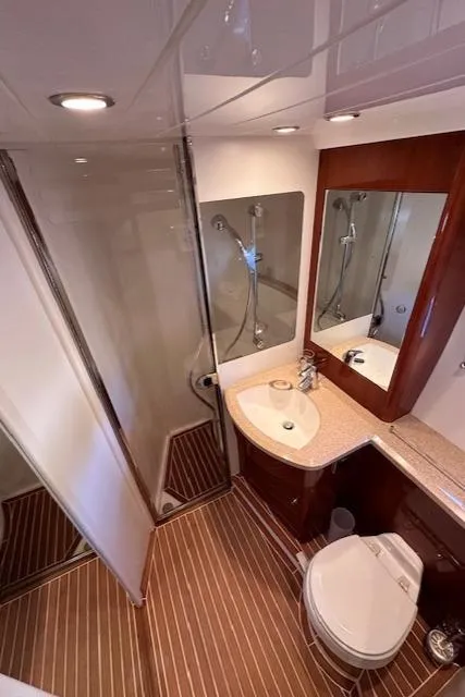 Slide: The Image of Luxurious bathroom in 2006 Princess 58v yacht with modern fixtures and wood accents. - 49