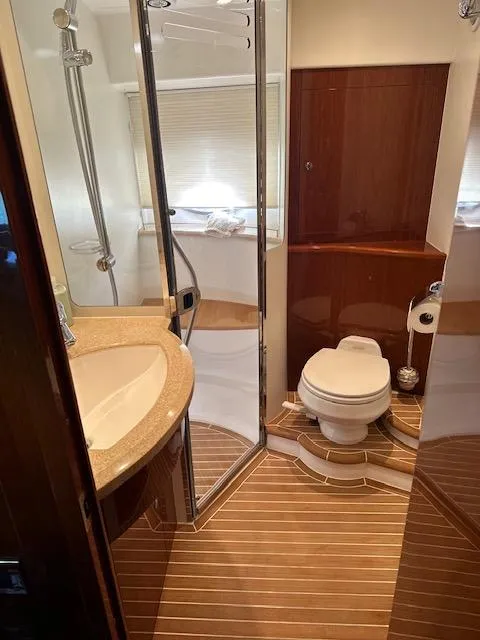 Slide: The Image of Luxurious bathroom in 2006 Princess 58v yacht with shower and wooden accents. - 5