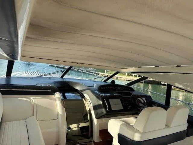 Slide: The Image of Interior of 2006 Princess 58v yacht with modern dashboard and seating. - 8