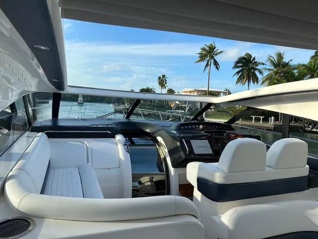 Slide: The Image of Luxurious 2006 Princess 58v yacht interior with white seating and scenic waterfront view. - 9