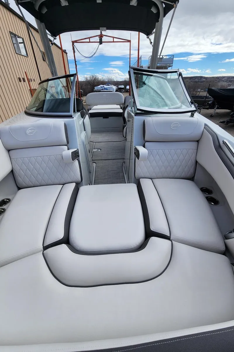 Slide: The Image of 2024 Crownline E235 boat with luxurious seating and modern design. - 10