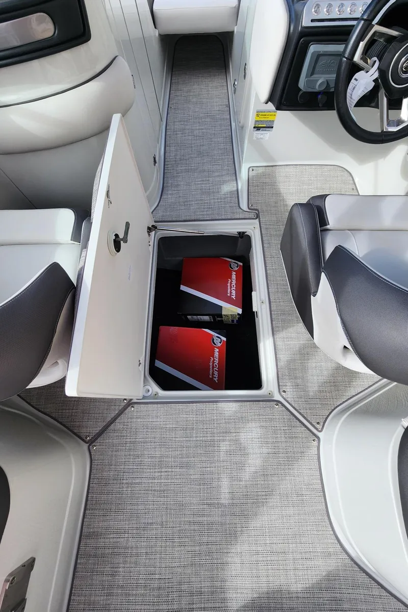 Slide: The Image of 2024 Crownline E235 boat interior with open storage compartment. - 14