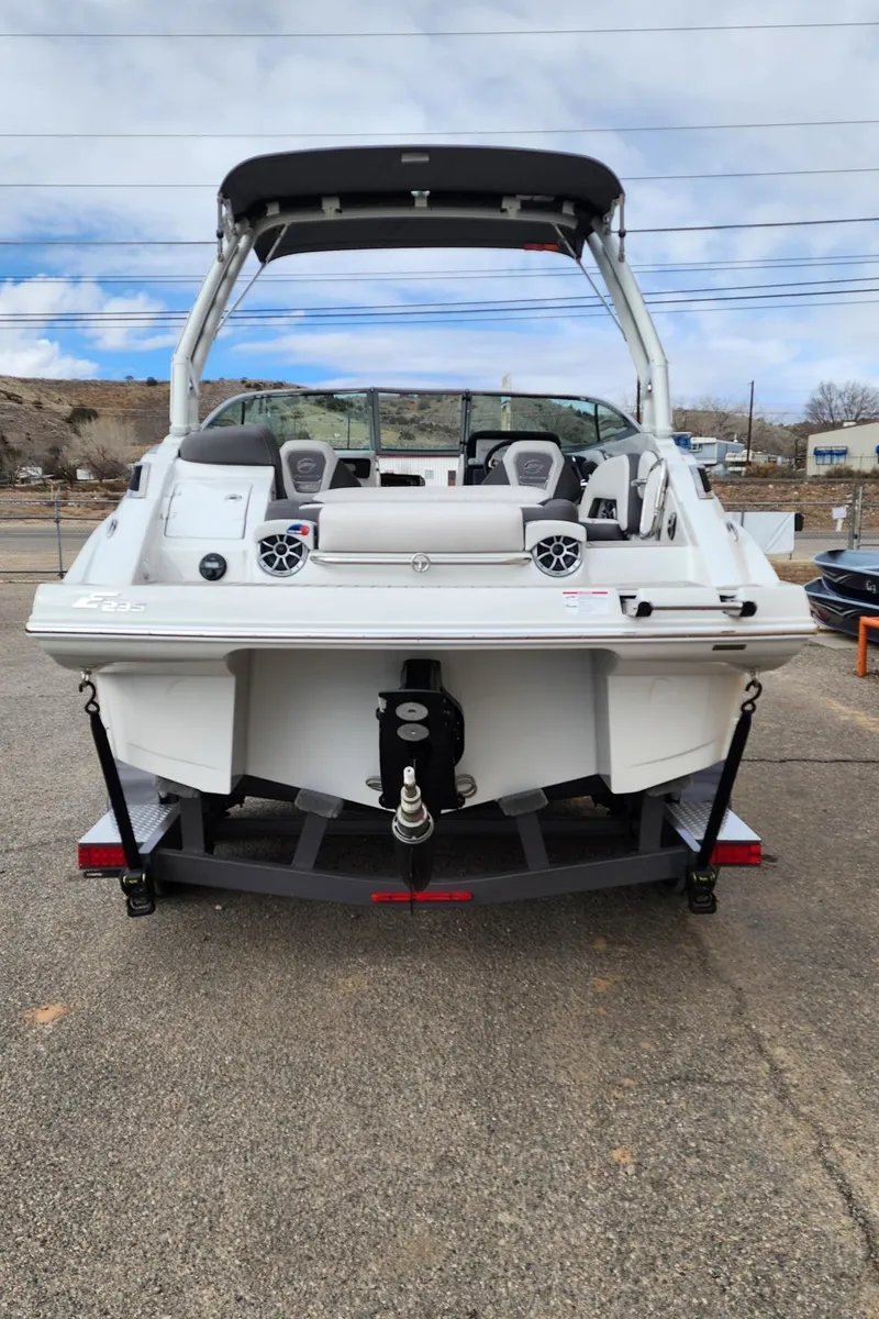 Slide: The Image of 2024 Crownline E235 boat, rear view, on a trailer. - 3
