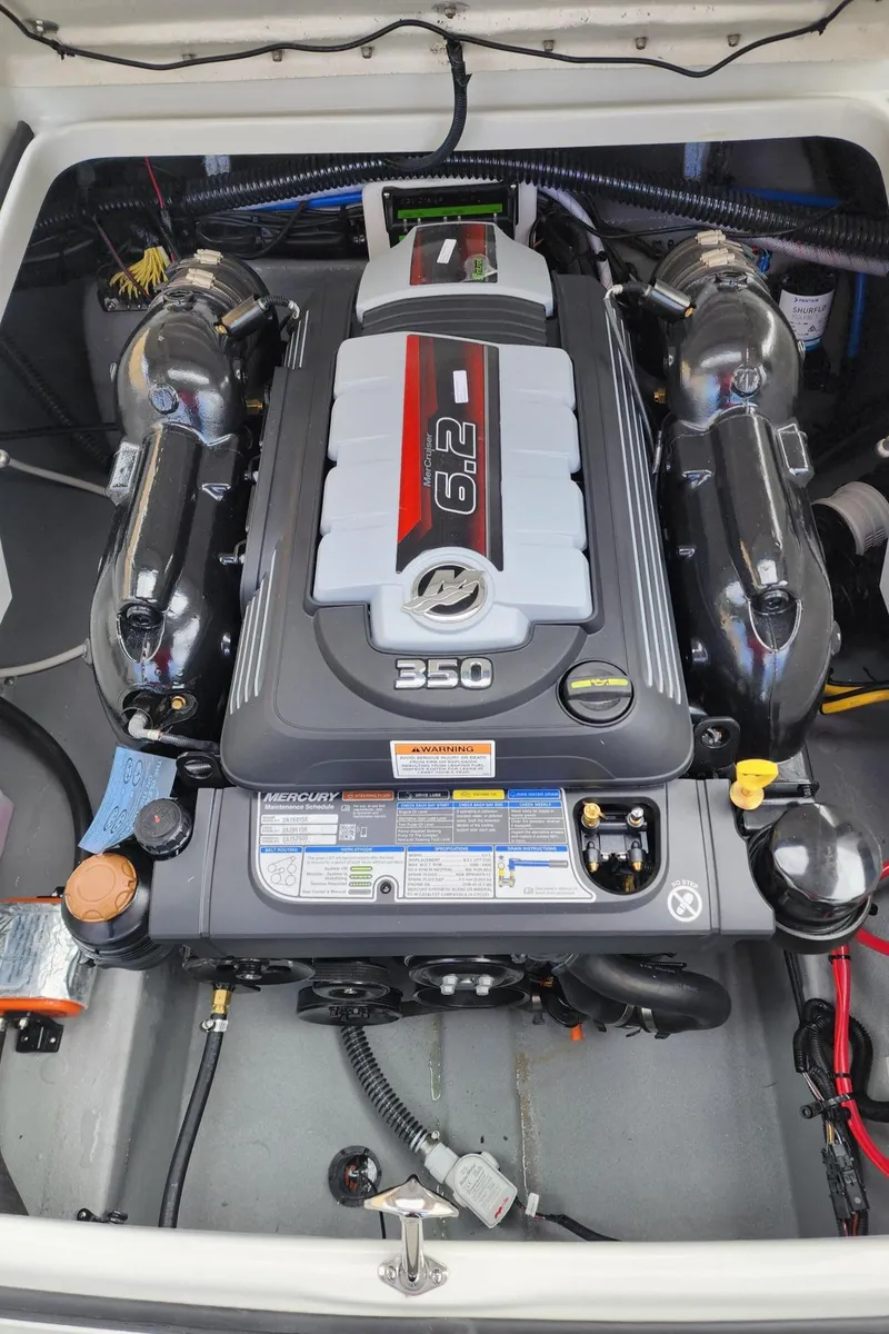 Slide: The Image of 2024 Crownline E235 boat engine compartment with a powerful 350 HP engine. - 4