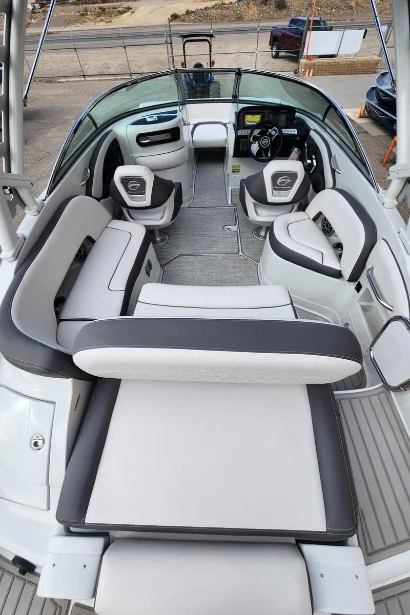 Slide: The Image of 2024 Crownline E235 boat interior with luxurious seating and modern dashboard. - 7
