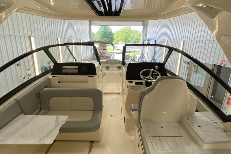 Slide: The Image of 2022 Scout 277 Dorado boat interior with seating and steering console. - 5