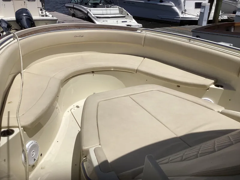 Slide: The Image of 2016 Chris-Craft 34 Catalina boat interior with beige seating at a marina. - 11
