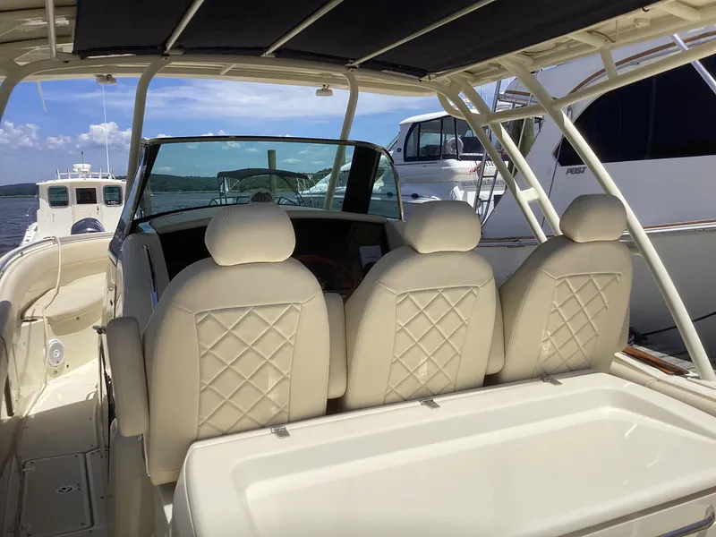 Slide: The Image of 2016 Chris-Craft 34 Catalina boat interior with beige leather seats. - 12