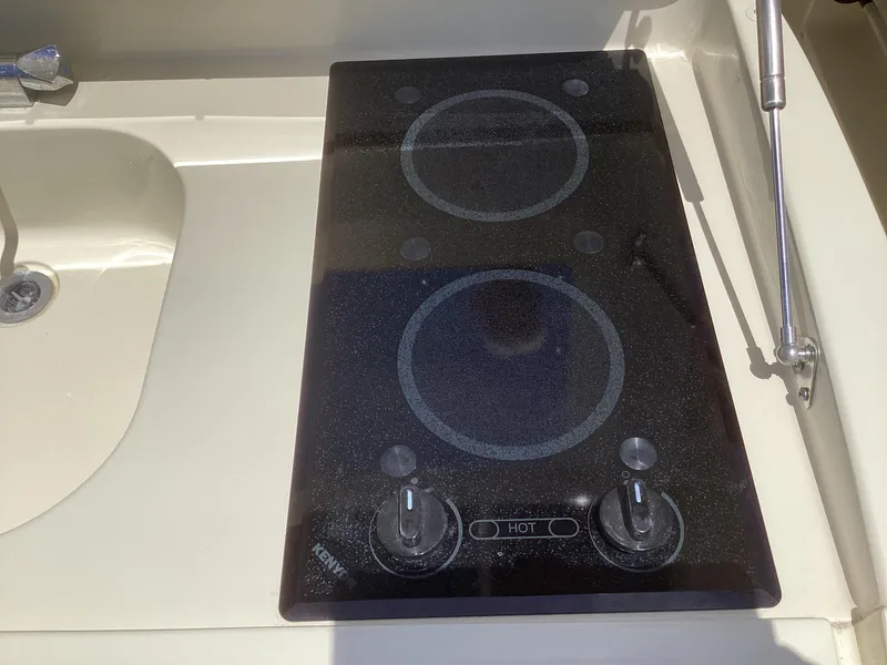 Slide: The Image of 2016 Chris-Craft 34 Catalina boat kitchen with electric stovetop. - 15