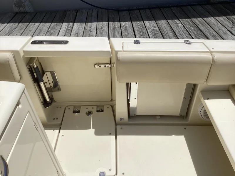 Slide: The Image of 2016 Chris-Craft 34 Catalina boat interior with beige seating and storage compartments. - 18