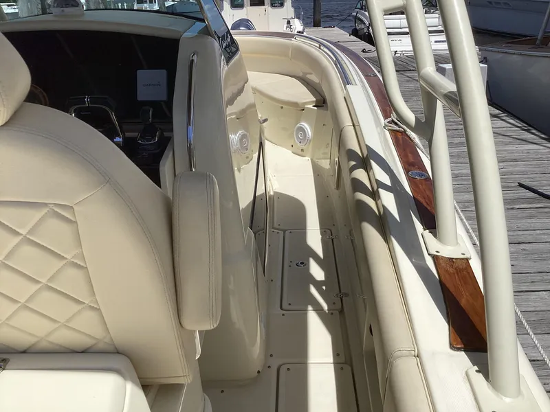 Slide: The Image of 2016 Chris-Craft 34 Catalina boat interior with beige seating and wood accents. - 19