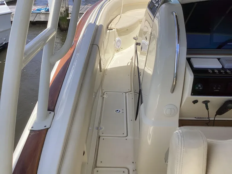 Slide: The Image of 2016 Chris-Craft 34 Catalina boat deck with white seating and control panel. - 20