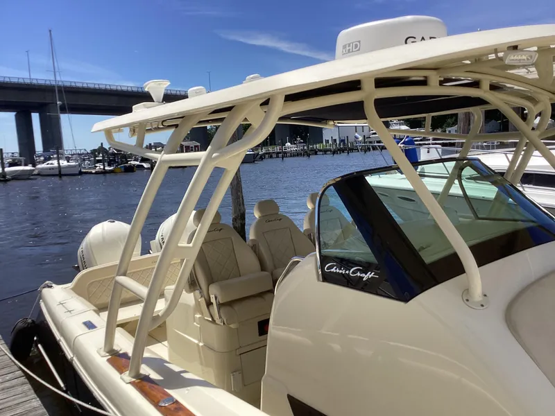 Slide: The Image of 2016 Chris-Craft 34 Catalina docked at a marina with bridge in background. - 31