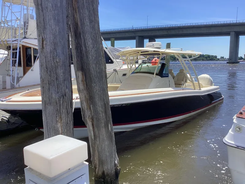 Slide: The Image of 2016 Chris-Craft 34 Catalina boat docked near a bridge on a sunny day. - 32
