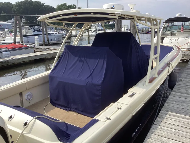 Slide: The Image of 2016 Chris-Craft 34 Catalina boat docked, covered with blue canvas. - 36