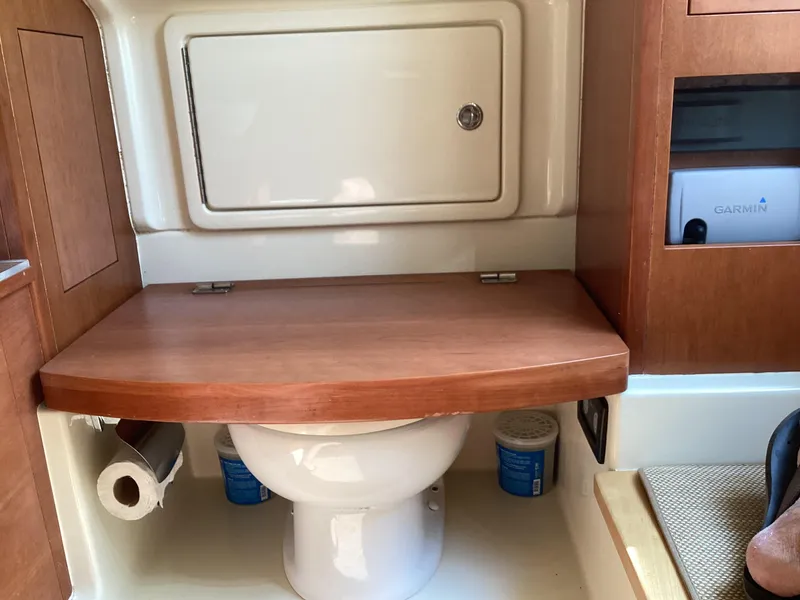 Slide: The Image of 2016 Chris-Craft 34 Catalina boat bathroom with wooden accents and storage. - 38