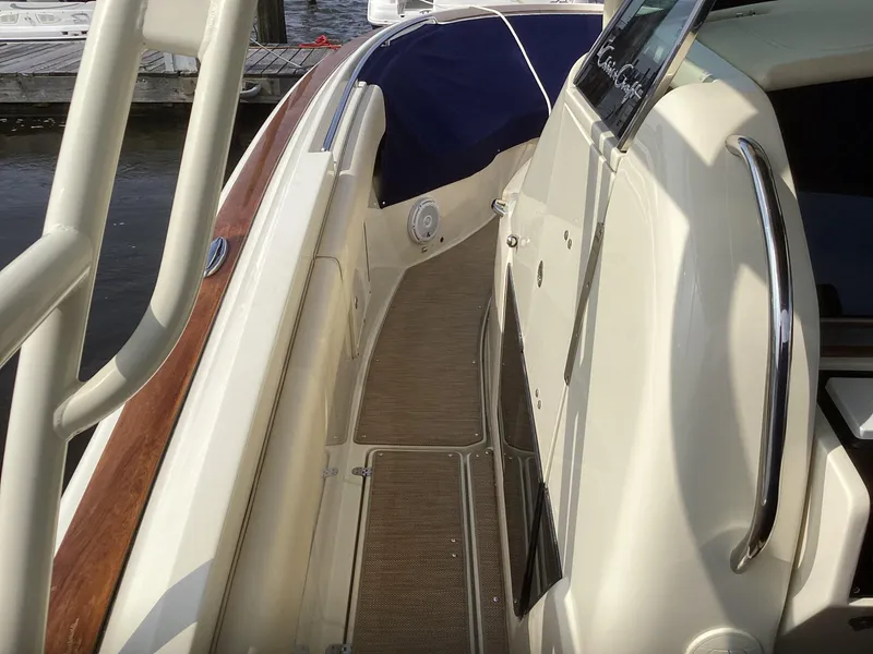 Slide: The Image of 2016 Chris-Craft 34 Catalina boat deck with wood accents and stainless steel railings. - 41