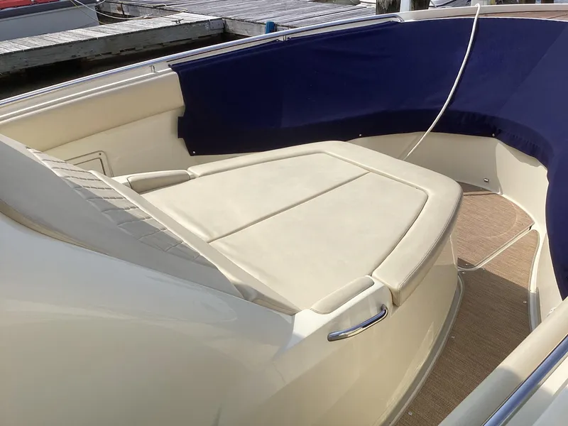 Slide: The Image of 2016 Chris-Craft 34 Catalina boat interior with cushioned seating and blue trim. - 43