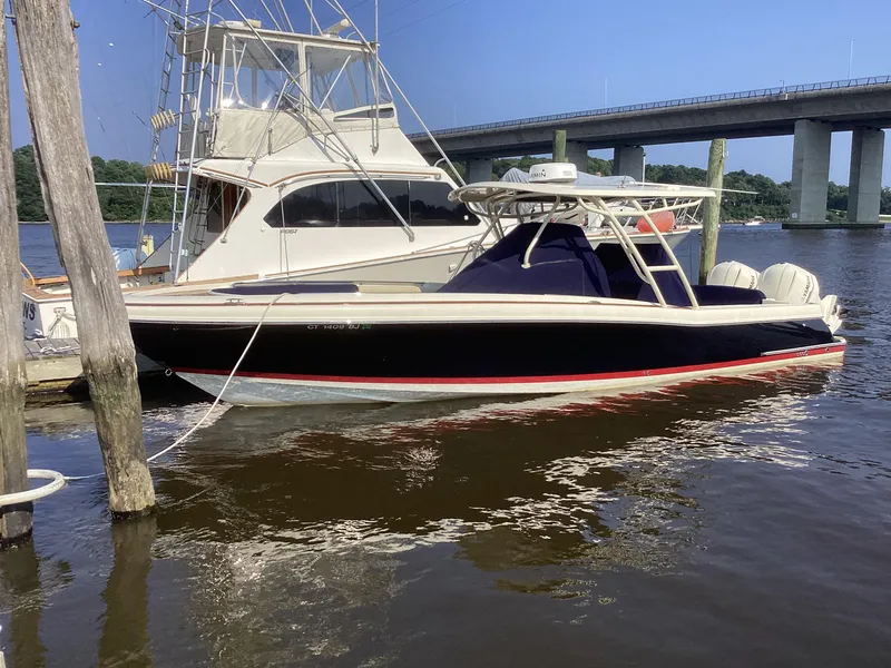 Slide: The Image of 2016 Chris-Craft 34 Catalina boat docked near a bridge on a sunny day. - 44