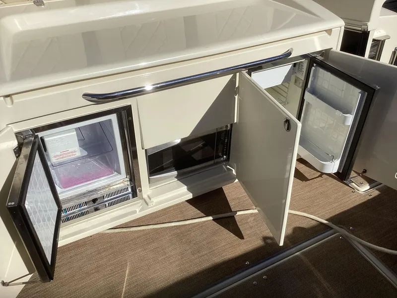 Slide: The Image of 2016 Chris-Craft 34 Catalina interior with open storage and refrigerator compartments. - 45