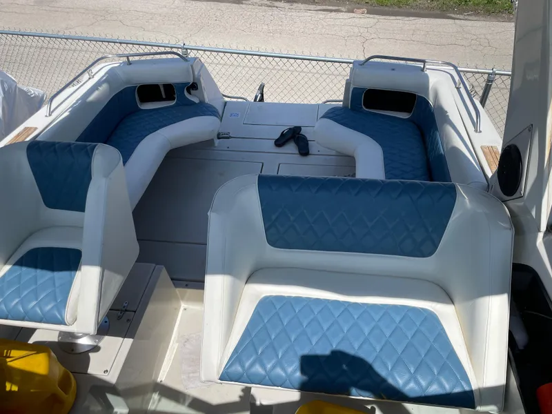 Slide: The Image of 1989 Cruisers Yachts 3060 Rogue interior with blue and white seating. - 2