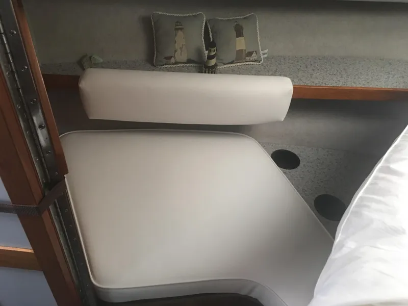 Slide: The Image of Interior cabin of 1989 Cruisers Yachts 3060 Rogue with white cushions and lighthouse pillows. - 4