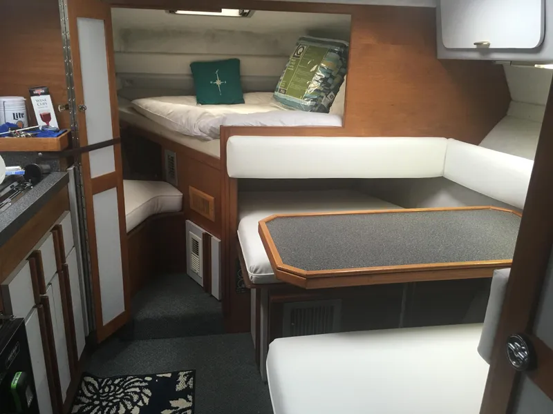 Slide: The Image of Interior of 1989 Cruisers Yachts 3060 Rogue with cozy seating and sleeping area. - 5