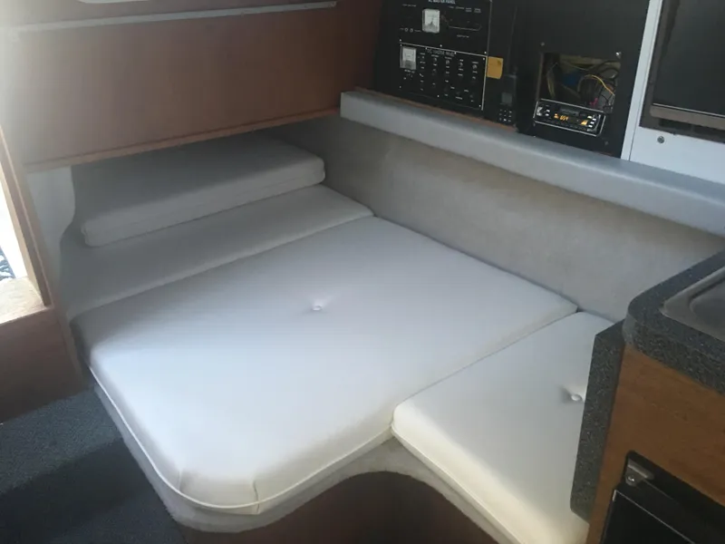 Slide: The Image of Interior cabin of 1989 Cruisers Yachts 3060 Rogue with white cushions and control panel. - 6