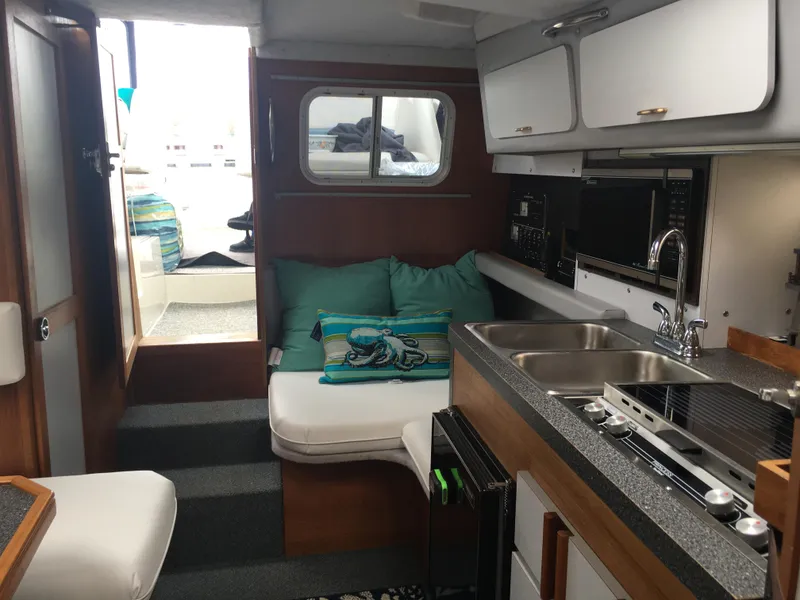 Slide: The Image of Interior of 1989 Cruisers Yachts 3060 Rogue with cozy seating and modern kitchen amenities. - 9