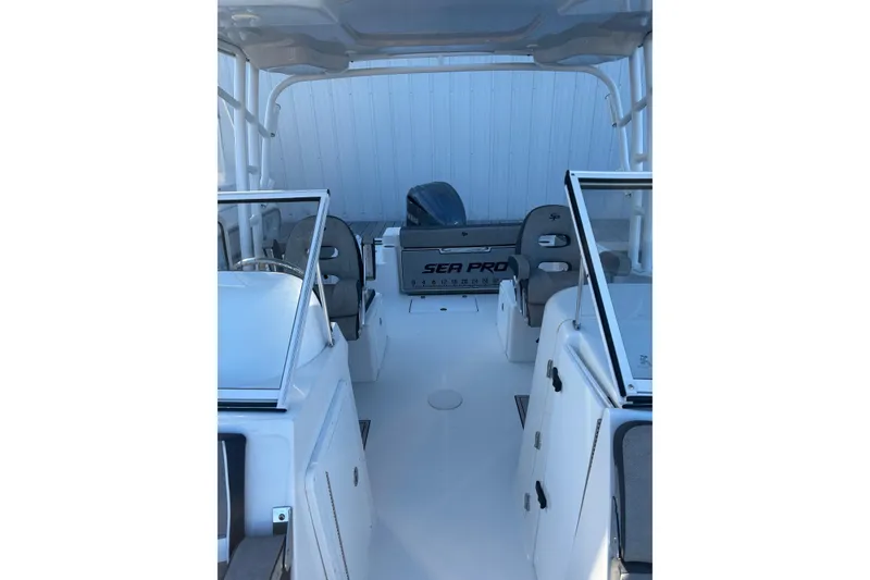 Slide: The Image of 2024 Sea Pro 240 Dual Console boat interior with seating and console view. - 5