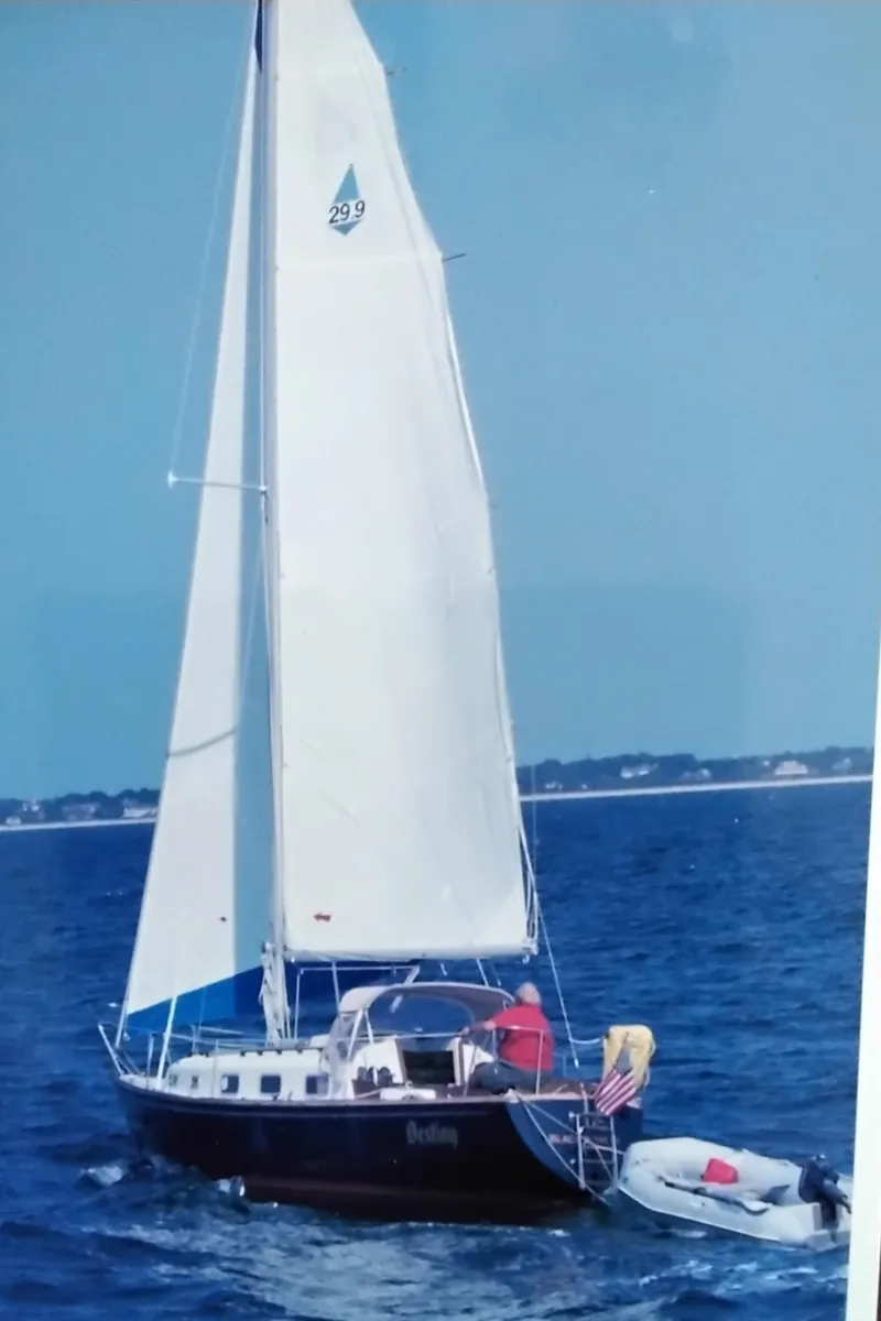 Slide: The Image of 1978 Bristol 29.9 Sloop sailing on open water with dinghy attached. - 1