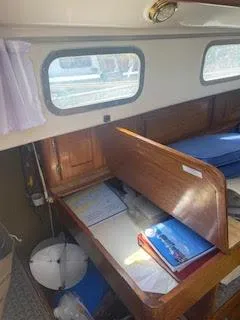 Slide: The Image of 1978 Bristol 29.9 Sloop interior with wooden desk and storage area. - 7