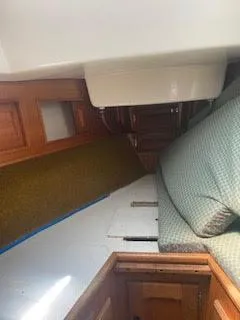 Slide: The Image of Interior of a 1978 Bristol 29.9 Sloop sailboat with wooden cabinetry and cushioned seating. - 9