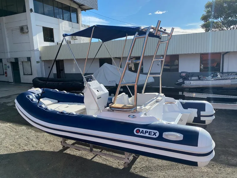 The Image of 2024 Apex A-18 Deluxe Tender boat with canopy, docked outdoors. - 1