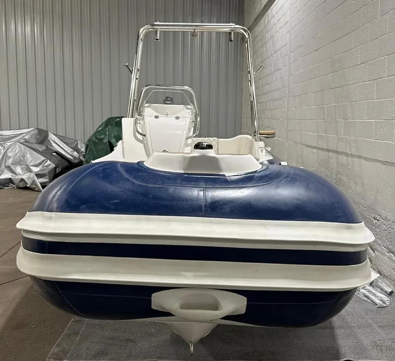 Slide: The Image of 2024 Apex A-18 Deluxe Tender boat in storage, front view. - 7
