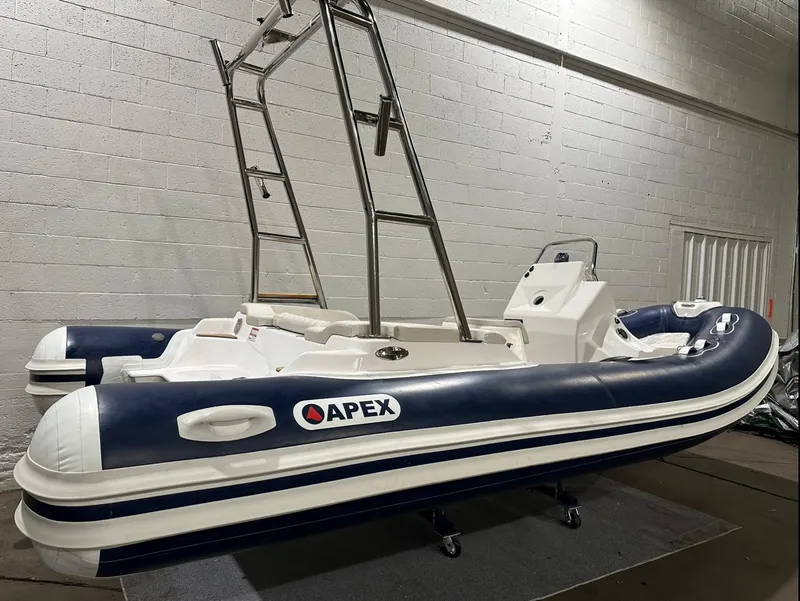 Slide: The Image of 2024 Apex A-18 Deluxe Tender boat in a showroom, featuring sleek design and modern features. - 4